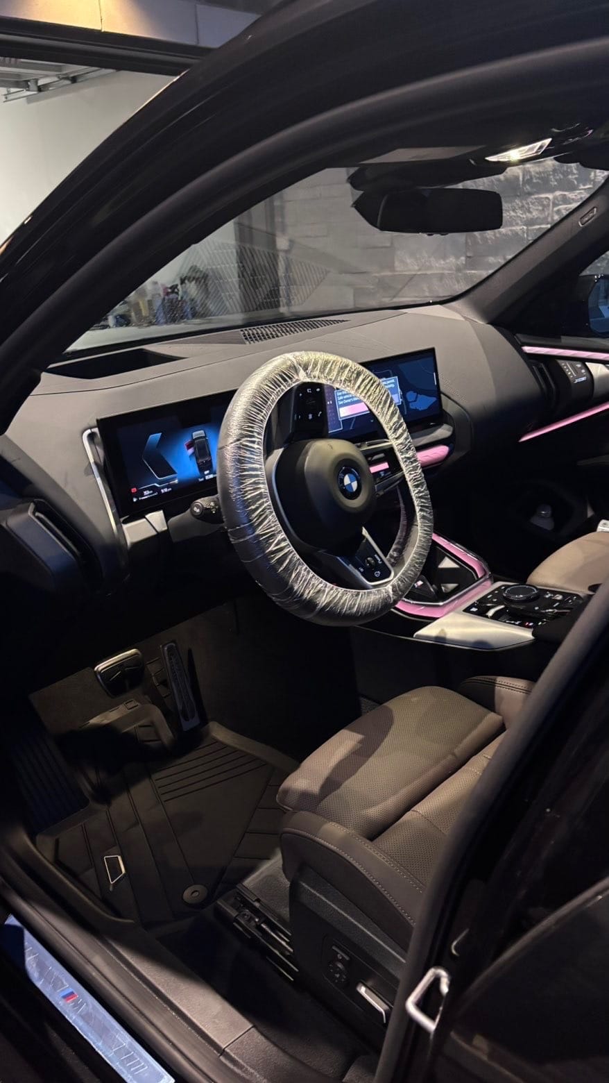 Freshly detailed BMW interior with spotless dashboard, screens and leather seats